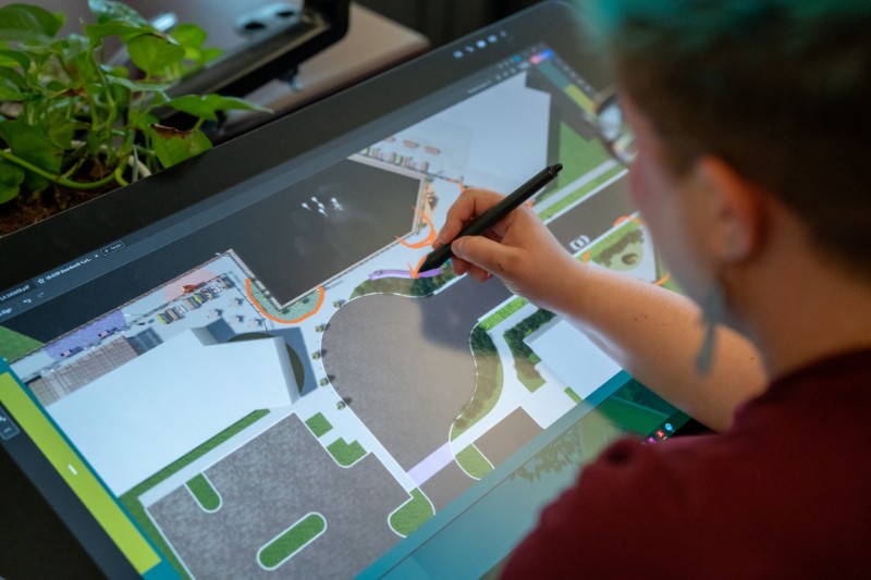 Bayer Becker Careers Designer drawing on a digital tablet with landscape plan.