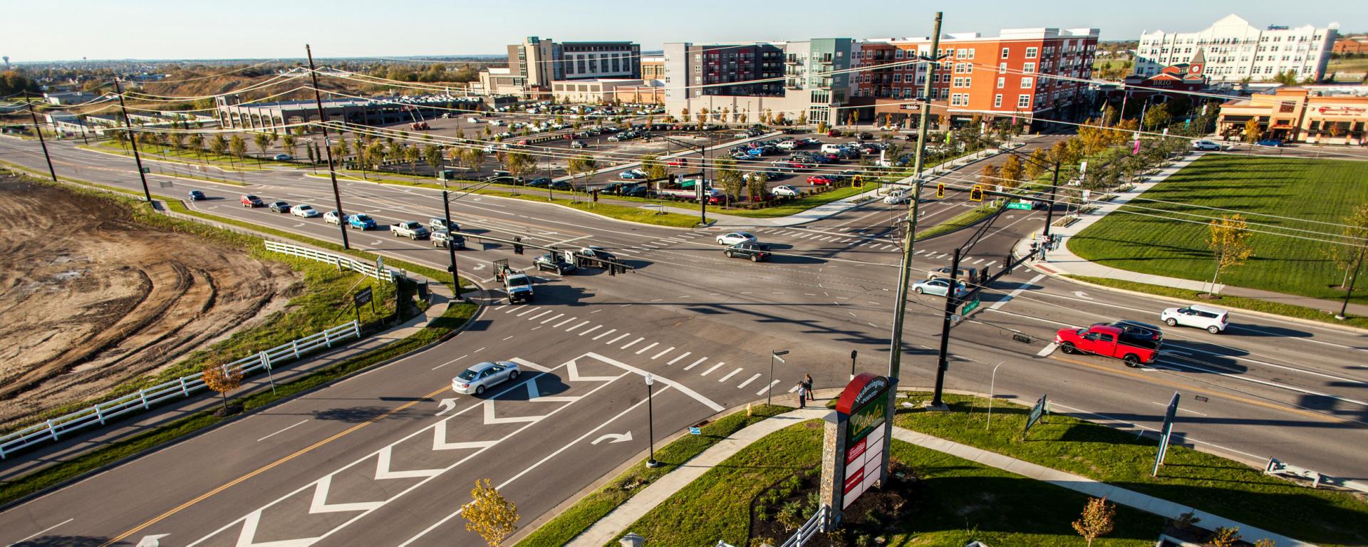 roadway intersection with shopping center development on one side