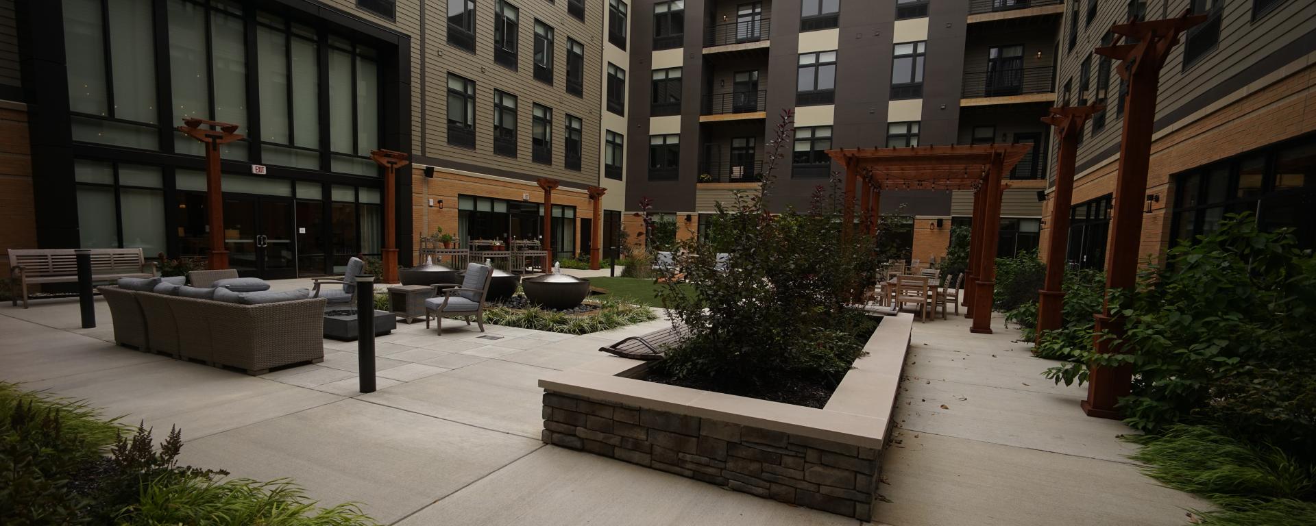 apartment courtyard with plantings and benches