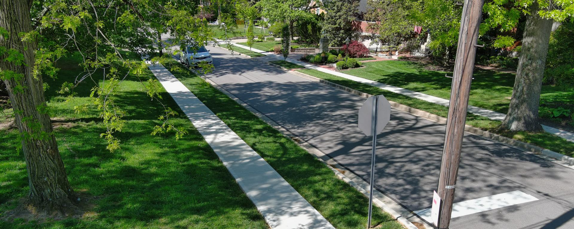 low altitude aerial photo of residential street and sidewalk