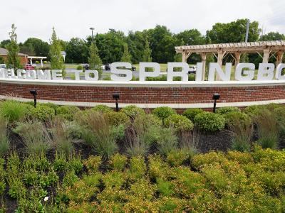Springboro Gateway welcome sign with green plants surrounding