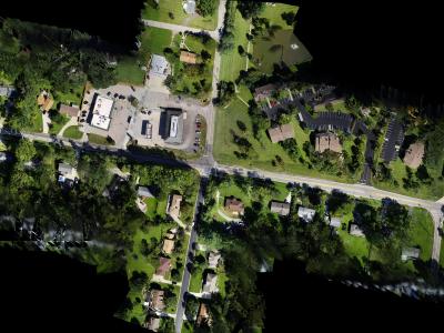 aerial photo of roadway intersection with houses on all sides